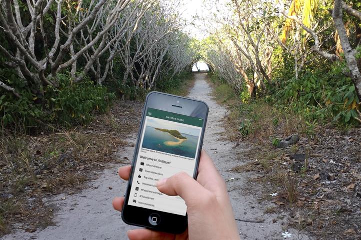 A phone shows the Antique Guide app, which features destinations such as the uninhabited Nogas Island. Local tourism gets digital boost from Smart