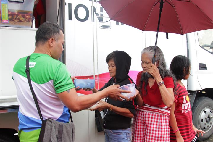 A Smart employee distributes lunch to Albay residents who have been affected by the eruption of Mayon during the Tulong Kapatid relief operations. Smart joins Mayon relief operations
