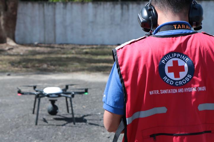 A volunteer prepares for drone takeoff during the launch of the drones and network solutions for disaster response. Disaster preparedness, response in communities boosted via tech, partnerships