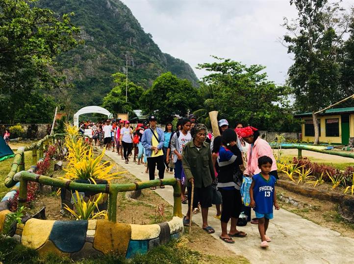 Residents of Sitio Botlog walk to Tambaliza High School, the designated evacuation center, during a hazard drill organized by Adra and supported by Smart. Iloilo communities boost preparedness through drill