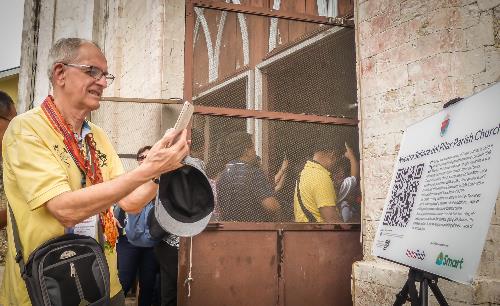 Bamboo Organ Foundation’s Fr. Leo Reiner scans the QR code at the Nuestra Señora del Pilar Parish Church in Sibonga, Cebu. Smart backs Church heritage conservation through digital tourism