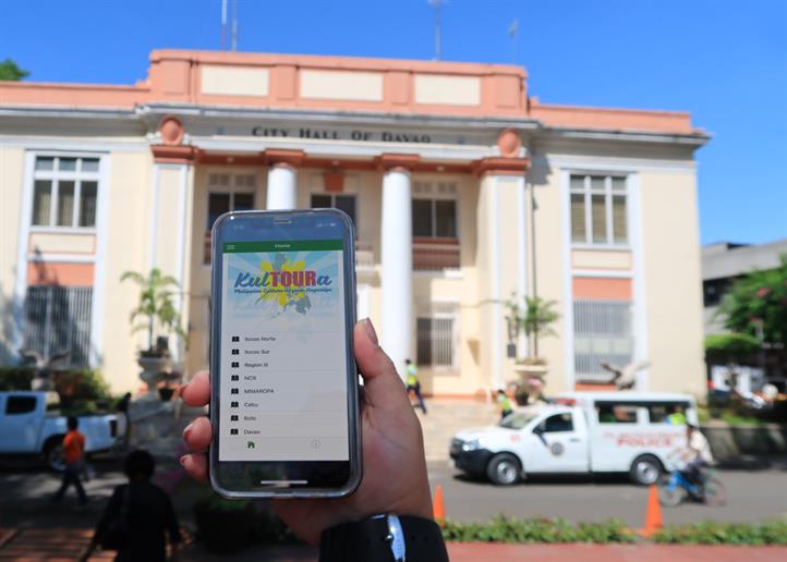 This photo shows the KulToura app, and the Davao City Hall on the background. Local tourism gets digital boost from Smart