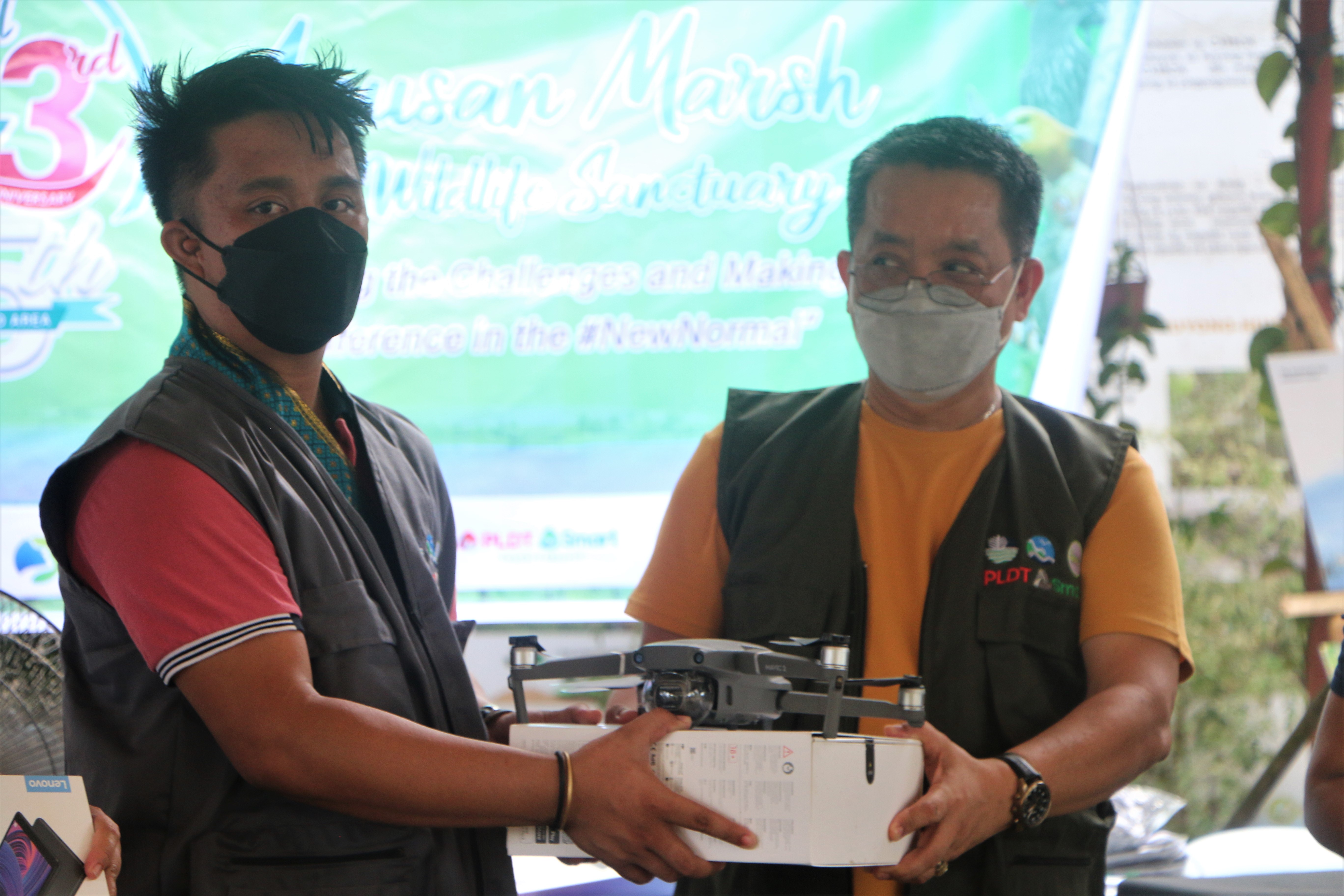 turn-over of drone by PLDT rep. John Deloso to DENR-13 RED Nonito M. Tamayo (right of photo)